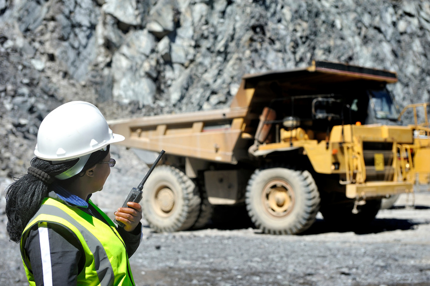 Female engineer supervises open pit mining